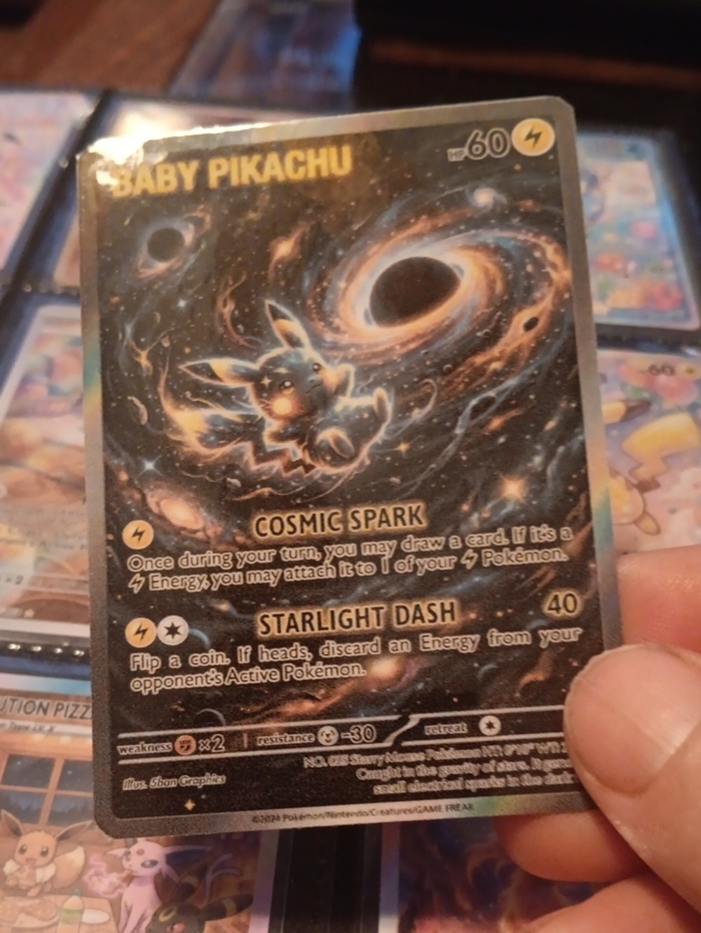 Baby Pikachu Cosmic Spark Holographic Card - Black/Gold